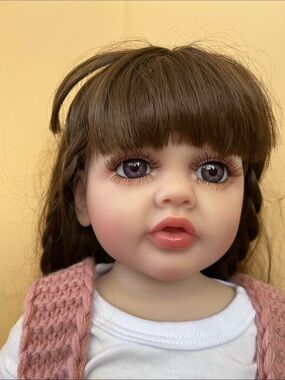Reborn Brown-Haired Doll with Pink Knit Vest and White Top